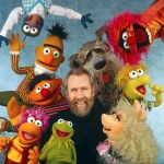 Jim_Henson_surrounded_by_Muppets_Fraggles_Sesame